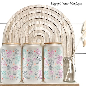 May include: Three frosted glass tumblers with wooden lids, decorated with a mermaid, cowboy boot, and seashell pattern in teal, pink, and black. The tumblers are displayed in front of a wooden rainbow arch.