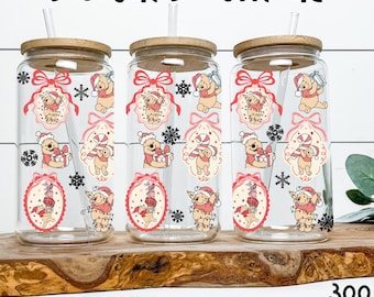 May include: Three clear glass tumblers with bamboo lids and straws. Each tumbler features a Christmas-themed design with a cartoon bear wearing a Santa hat, snowflakes, and the text "Digital Download" and "Digital Barn Boutique".