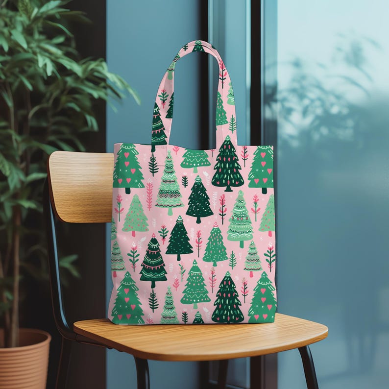 May include: A pink tote bag with a repeating pattern of green Christmas trees and red heart accents. The trees are of various styles and sizes, set against a light pink background. The bag has matching handles.