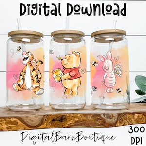 May include: Three glass tumblers with bamboo lids and straws, each featuring a different character from Winnie the Pooh: Tigger, Winnie the Pooh, and Piglet. The tumblers have a watercolor background and the text "Digital Download" and "Digital Barn Boutique".