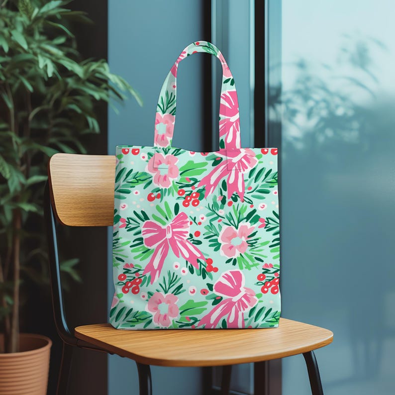 May include: A tote bag with a floral design of pink bows, flowers, and red berries on a pale green backdrop. The bag has matching pink handles. Ideal for carrying shopping or personal belongings, it's made from a durable material.