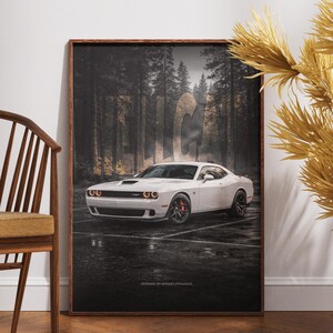 May include: A framed print featuring a white sports car parked on a wet surface in front of a forest backdrop. The car has black wheels with red brake calipers. The text "DESIGNED BY MONKFLIPGARAGE" is at the bottom.