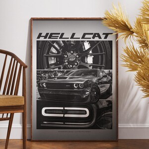 May include: Framed black and white print featuring a Dodge Hellcat. The image is divided into three sections, showcasing the car's wheel, front, and grill. The word "HELLCAT" is printed at the top. The print is displayed in a room with a wooden chair.