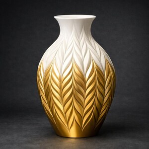 May include: A decorative white and gold vase with a textured, leaf-like pattern. The upper portion is white, transitioning to a gold base. The vase has a wide, rounded body and a narrow neck, suitable for home decor.