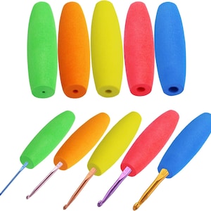May include: A collection of colorful crochet hooks and matching foam handles. The handles are in green, orange, yellow, red, and blue. The hooks are made of metal and have different colored tips. The tools are designed for various crafting projects.