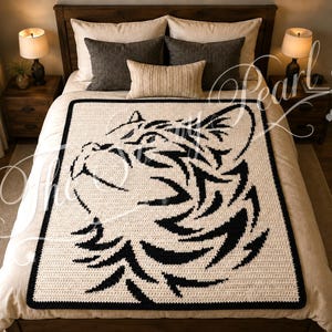 May include: A rectangular crochet blanket featuring a high-contrast black and cream tiger head graphic. The design is centered on the fabric, showcasing the feline's profile with detailed black stripes against a solid cream background and a black border.