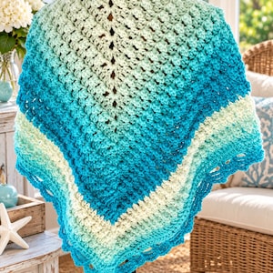 May include: A triangular crochet shawl featuring a gradient color pattern that transitions from light mint green at the top to vibrant turquoise and deep blue at the bottom edges, finished with a decorative scalloped border.