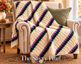 May include: A crocheted throw blanket featuring diagonal stripes in cream, dark green, and purple. The blanket is draped over a beige upholstered armchair. The text "The Savvy Pearl" is printed in white at the bottom of the image.