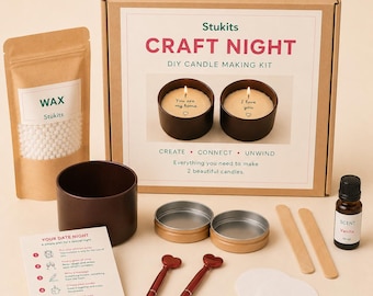 May include: A DIY candle making kit in a cardboard box labeled Stukits Craft Night. Includes a bag of white wax beads, a dark brown candle tin, two metal lids, two red heart-topped pens, two wooden stir sticks, two round white labels, and a bottle of vanilla scent.