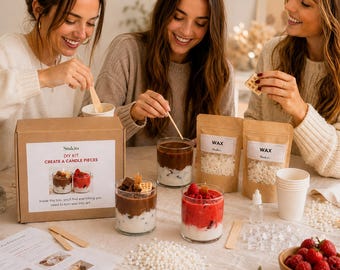 May include: A DIY candle making kit featuring a cardboard box labeled Stukits, two pouches of white wax beads, two glass jars with layered wax resembling chocolate and strawberry desserts, wooden stir sticks, and a printed instruction sheet.
