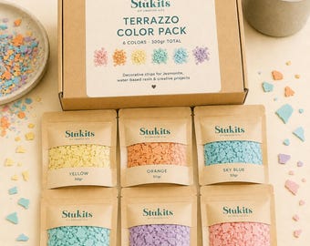 May include: A Stukits Terrazzo Color Pack box containing six 50g pouches of decorative chips in yellow, orange, sky blue, turquoise, violet, and pink. The box label reads Terrazzo Color Pack, 6 Colors, 300gr Total, and Decorative chips for Jesmonite.
