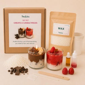 May include: A DIY candle making kit featuring a cardboard box labeled Stukits Create a Candle Pieces, a pouch of white wax beads, two glass candles with chocolate and berry designs, fragrance oils, a wooden stirrer, and decorative wax toppings.