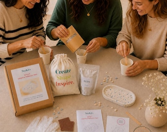 May include: A DIY terrazzo tray kit including a cardboard box with a product label, a white drawstring bag printed with Create Shape: Inspire., a resin pouch, a finished oval terrazzo tray, white gloves, instructions, and small colored chips.
