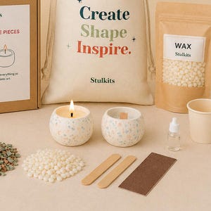 May include: A candle making kit featuring a canvas drawstring bag with the text Create Shape Inspire. Stulkits, a pouch of white wax beads, two speckled ceramic bowls, a small bottle of oil, wooden stir sticks, a sanding block, and wax pellets.