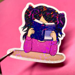 Girl reading and studying DSM-5 sticker featuring a cute girl wearing pink with bows in her black hair, psychology humor sticker for grad students and therapists