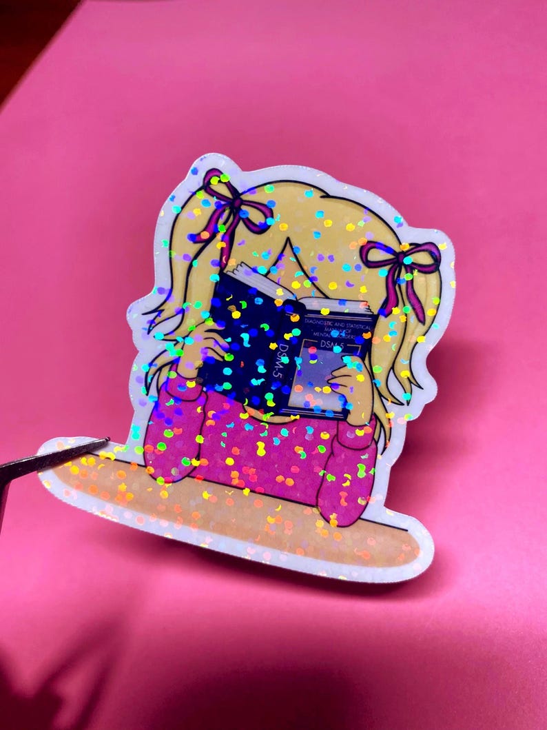 Girl reading and studying DSM-5 sticker featuring a cute girl wearing pink with bows in her blonde hair, psychology humor sticker for grad students and therapists