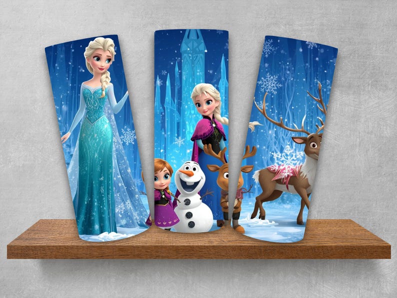 Puede incluir: Tres vasos cil&iacute;ndricos con personajes de Frozen. El primero muestra a Elsa con un vestido azul. El segundo muestra a Anna, Olaf y Sven. El tercero presenta un reno en un paisaje nevado con tonos azules, copos de nieve y un castillo de hielo.