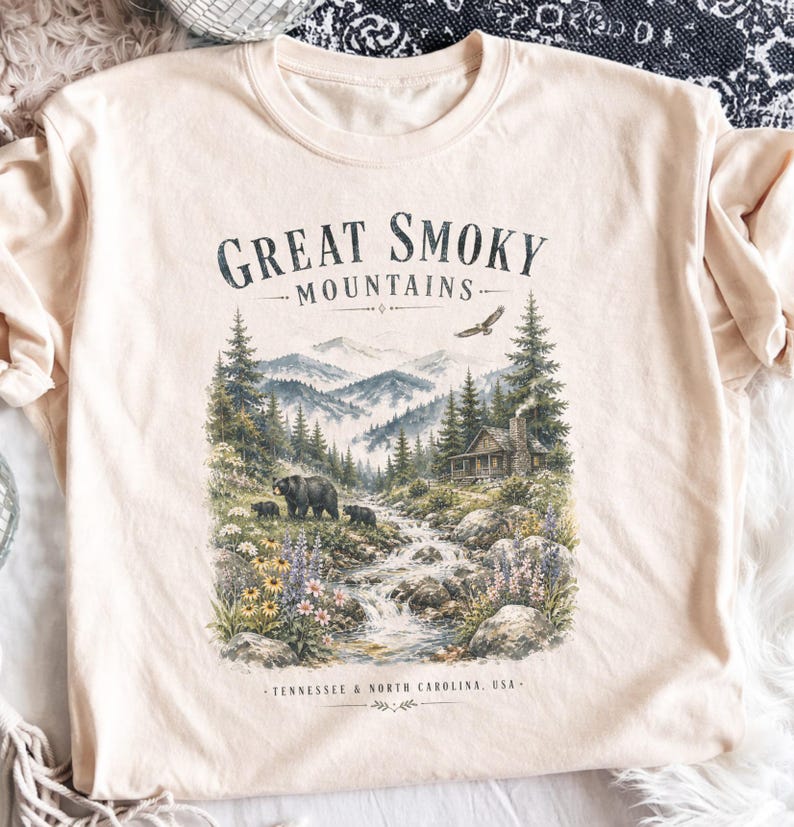 Great Smoky Mountains graphic t-shirt with bears, cabin, and scenic mountain landscape.