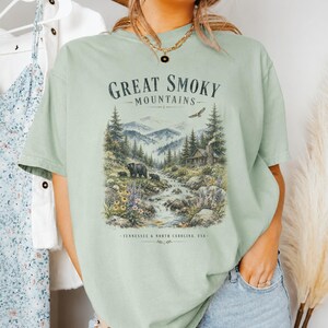 Great Smoky Mountains illustration with bears, cabin, waterfall, and text.