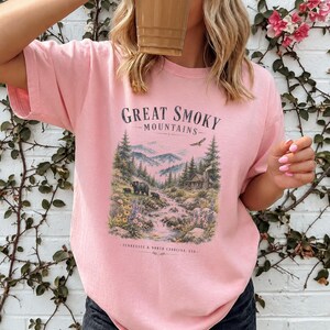 Pink t-shirt with "Great Smoky Mountains" and a mountain cabin scene with bears.