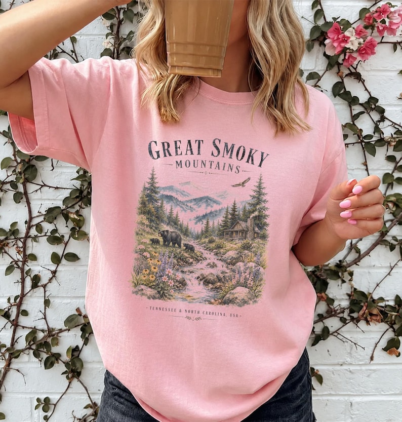 Pink t-shirt with "Great Smoky Mountains" and a mountain cabin scene with bears.