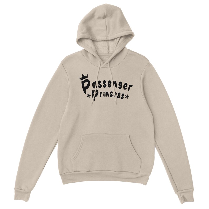 May include: A beige hooded sweatshirt with a front pocket. The front features the black text "Passenger Prinssss", with a crown above "Passenger" and stars around "Prinssss".