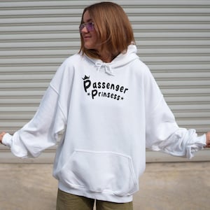 May include: White hoodie with the text "Passenger Prinssess" in black script. The sweatshirt has a front pocket and a drawstring hood. The image shows a person wearing the hoodie.