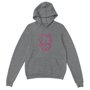 May include: A gray hooded sweatshirt featuring a pink outline of a cartoon cat character on the front. The sweatshirt has a kangaroo pocket and a drawstring hood. The cat has a bow and is wearing a dress.