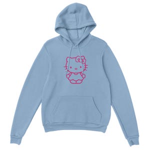 May include: A light blue hoodie featuring a pink outline of a cartoon cat character. The hoodie has a drawstring hood and a kangaroo pocket. The cat character has a bow and is centered on the front of the garment.