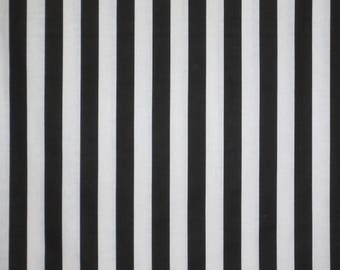 May include: Black and white striped fabric with vertical stripes.