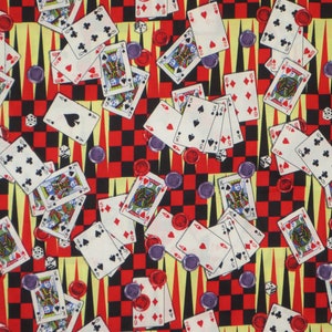 May include: A colorful fabric with a repeating pattern of playing cards, dice, and game pieces. The background is a checkerboard pattern of red and black squares.