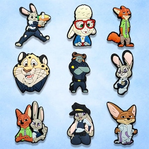 May include: A collection of cartoon character shoe charms featuring various animals. The charms include a rabbit in a police uniform, a sheep wearing glasses, a fox in a green shirt, and a leopard. The charms are colorful and detailed.