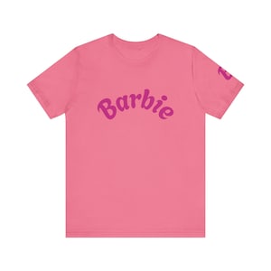Barbie Inspired Unisex Tee, Cute Graphic Shirt, Perfect Gift for Kids and Adults, Trendy Summer Wear, Party Attire, Nostalgic Fashion