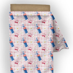 May include: A roll of fabric featuring a repeating pattern of blue soda bottles, cherries, and white daisies on a pink and white gingham background. The fabric is rolled up, showing the pattern on the surface.