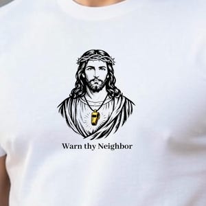 May include: White t-shirt featuring a black and gold illustration of a figure with a crown of thorns and a whistle pendant. The text "Warn thy Neighbor" is printed below the illustration.