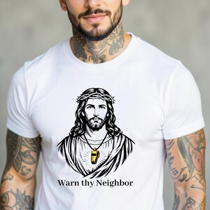 May include: White t-shirt featuring a black and white illustration of Jesus wearing a crown of thorns. A gold whistle hangs from a necklace. The text "Warn thy Neighbor" is printed below the illustration.