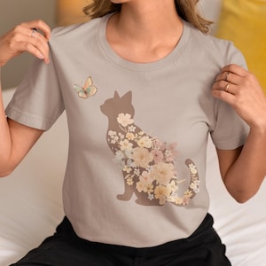 Whimsical Floral Cat & Butterfly T-Shirt Soft Muted Earth Tone Design Cat Lover Unisex Tee Playful Cat Flower Shirt