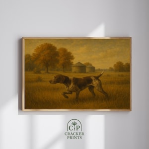 May include: A framed print featuring a hunting dog in a field. The dog is brown and white, with a focused expression. The background includes trees, a barn, and a golden-toned sky. The print is labeled "Cracker Prints".