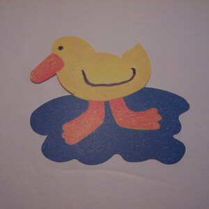 May include: A yellow duck with an orange beak and feet is standing on a blue cloud.