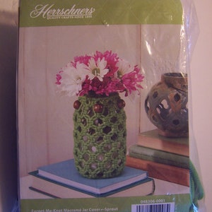 May include: A green macrame jar cover kit with wooden beads. The kit includes instructions and is called "Forget-Me-Knot Macrame Jar Cover-Sprout".