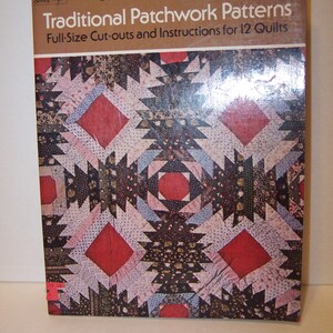 May include: A book titled "Traditional Patchwork Patterns" by Carol Belanger Grafton. The book cover features a colorful patchwork quilt design with red, black, white, and pink fabric.