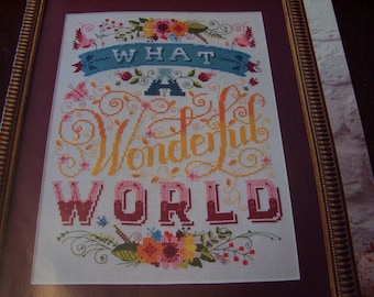 Wonderful World sampler cross stitch pattern with full color and symbol charts