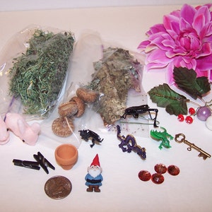 May include: A collection of miniature fairy garden accessories, including a gnome, a dragon, a key, a pot, a flower, a bug, and two bunnies. There are also acorns, moss, and beads.