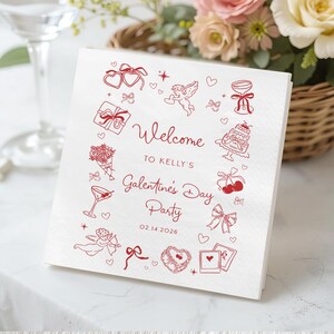 May include: White square paper napkins with red illustrations and text. The design includes hearts, bows, gifts, and the words "Welcome to Kelly's Galentine's Day Party 02.14.2026". A festive and decorative item for a party.