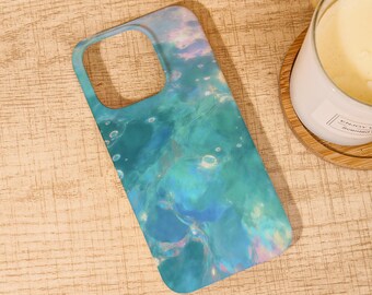 May include: A teal and blue phone case with a watercolor design. The case features a swirling pattern of blues, greens, and hints of pink, resembling an abstract ocean or sky. The case has cutouts for the camera and buttons.