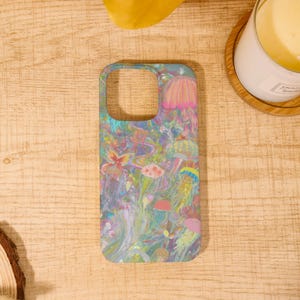 May include: A phone case featuring a vibrant, colorful design of jellyfish and other sea life. The case has a light blue background with pink, yellow, and green accents. The design is artistic and whimsical, perfect for adding a unique touch to your phone.