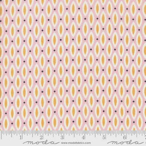 May include: Pink fabric with a repeating pattern of gold and white ovals, interspersed with small black dots. The fabric has a ruler along the bottom edge, with the word "moda" printed on it.