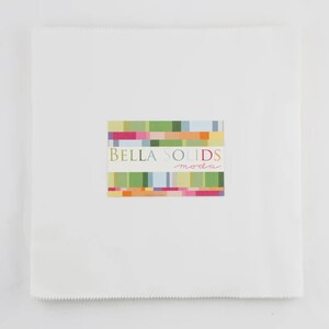 May include: A white fabric square with a colorful label that reads "Bella Solids moda".