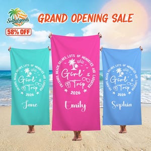 May include: Three beach towels in teal, pink, and blue, each held up by a person on a sandy beach. The towels feature a circular design with the text "Girl's Trip 2026" and the names Jane, Emily, and Sophia. The image also includes the text "Grand Opening Sale".