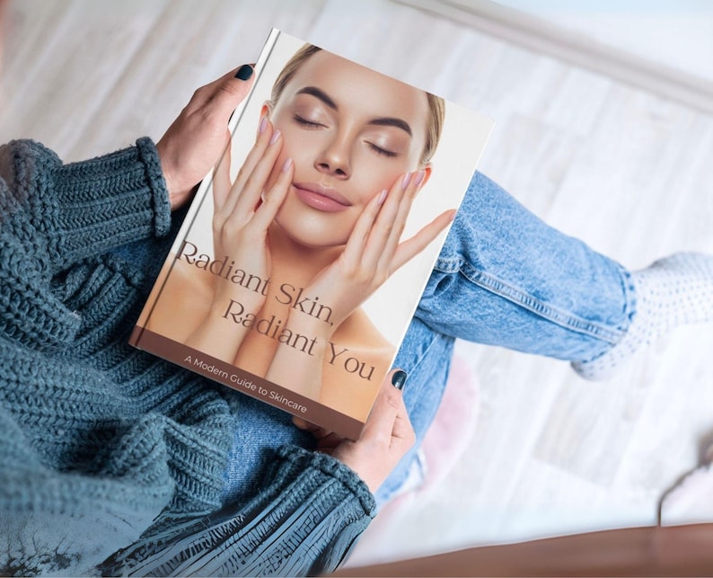 Puede incluir: Una persona sostiene un libro titulado "Radiant Skin, Radiant You: A Modern Guide to Skincare". La portada muestra a una mujer con los ojos cerrados, toc&aacute;ndose la cara. La persona lleva un jersey verde azulado y vaqueros azules.